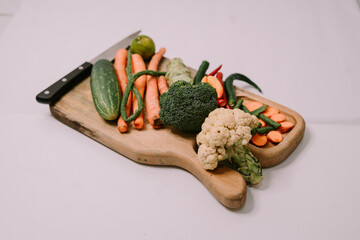 Colorful assortment of fresh vegetables, including tomatoes, bell peppers, and leafy greens, arranged beautifully to symbolize World Vegan Day and promote healthy eating