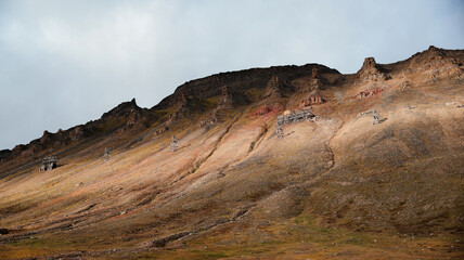 Exploration of mountain terrain near Longyearbyen highlighting abandoned ski lifts in Svalbard