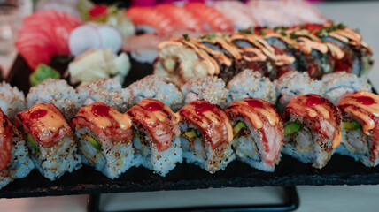 Delicious sushi platter featuring rolls and sashimi at an elegant restaurant during dinner