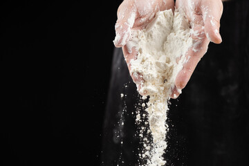 Cook pouring wheat white flour, hands close-up, copy place for text.