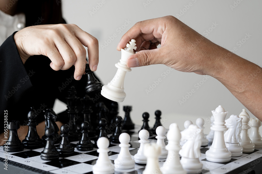 Wall mural hand two business moving chess in competition shows leadership, followers and business success strat