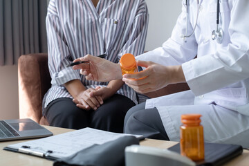 Female doctors who treat patients make an appointment to listen to the results after a physical examination and explain medical information and diagnose the disease. Medical concepts and good health