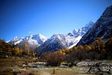 Perfect autumn and snowy mountains in Bipenggou, Sichuan, China