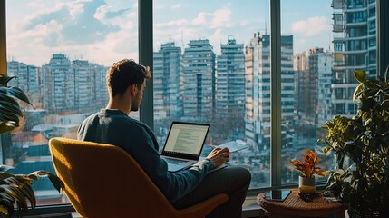 Man Working on Laptop in a Modern Apartment with City View