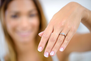 Lady showing engagement ring on hand