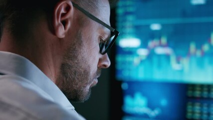 Close-up of stock market analyst working in front of computer screen - Powered by Adobe