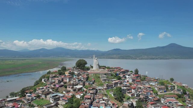 Orbital aerial shot to the left of the Morelos monument in Janitzio Michoacan