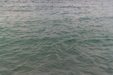 Sea surface with waves. Abstract background of water flow in ocean, sea, river, lake. Seascape wallpaper.