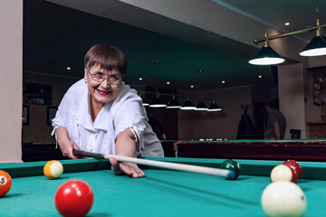 Fototapeta premium Grandma is relaxing in a billiard club.