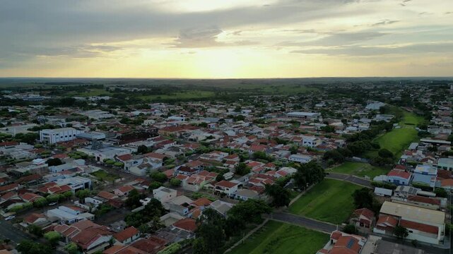 Aerial wide angle view of a small city in the country side of Sao Paulo during sunset time - Dracena, Brazil