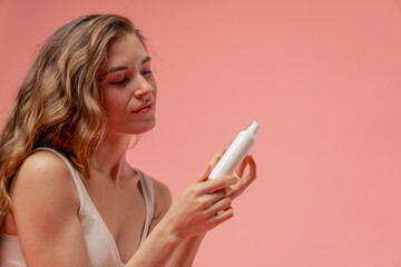 close up studio beauty shoot on pink background long-haired girl sitting posing in underwear with...