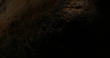 Dark, Textured Rock Surface with Deep Shadows