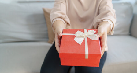 Happy woman hugging gift box. Receiving Valentine present. Cheerful girl with Xmas present or open box xmas new year birthday gift