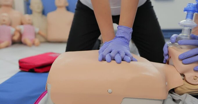 CPR training using and an AED and bag mask valve on an adult training manikin.