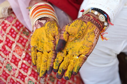 Indian wedding ritual where turmeric paste is applied to the bride's and groom's hands, symbolizing purity, prosperity, and blessings for their new journey together.