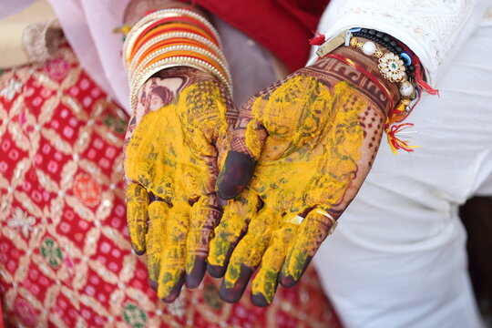 Indian wedding ritual where turmeric paste is applied to the bride's and groom's hands, symbolizing purity, prosperity, and blessings for their new journey together.