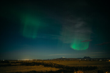 Aurora borealis above Icelanding farm on the night sky