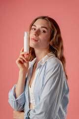 close up  studio beauty shoot on pink background long-haired girl sitting posing in underwear in...