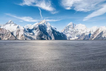 Fotobehang Asphalt road square and snow mountain natural landscape under blue sky. car background. © ABCDstock