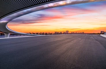 Gordijnen Asphalt road and bridge with sky clouds natural landscape at dusk. road trip. © ABCDstock