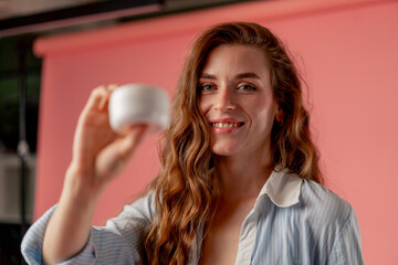 close up studio beauty shoot on pink background long-haired girl posing in underwear and blue shirt...