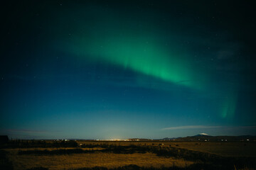 Aurora borealis above Icelanding farm on the night sky