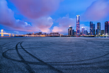 Obraz premium Asphalt road square and modern city buildings scenery at night in Zhuhai, China. car advertising background.
