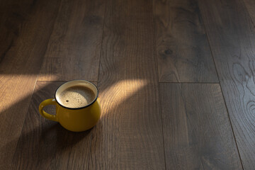 Coffee in a cup on a wooden surface