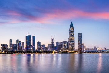 Shenzhen skyline and modern city buildings scenery by the lake at night. Famous modern commercial...