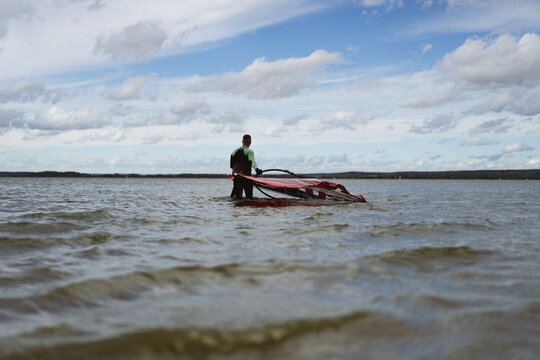 A man is windsurfing on the lake (flysurfing)