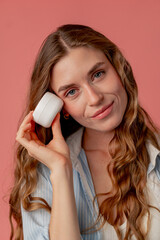 close up studio beauty shoot on pink background long-haired girl posing in underwear and blue shirt...