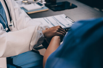 Kind male doctor wearing white coat consulting elder senior female patient holding hand of older woman giving help, safety, empathy and support, showing care and compassion concept. Close up view