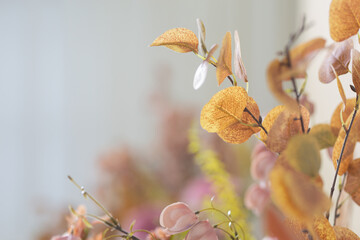 Yellow leaves on a white curtain background Leave the copy space.