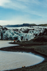 Icelandic sheep grazing in Iceland. Excursion groupd are preparing for trekking.