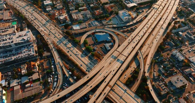 Lively traffic on the highways, loops and freeways in Los Angeles downtown. Approaching famous interchange in metropolis midtown.