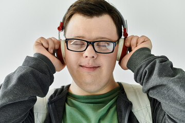 A man with Down syndrome immerses himself in music while relaxing at home.