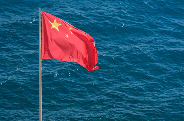 Chinese national flag at the coast near the sea