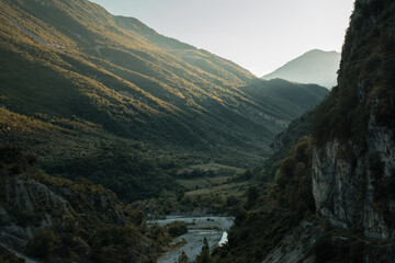 Albanian mountains with canyon and river in golden hour light. Balance between shadows and light. 
