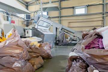 Industry Plant for sorting and processing plastic and paper waste. Conveyor assembly line with garbage bottles and packaging