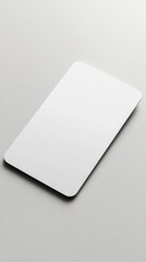 A white matte credit card mockup lies flat on a light grey surface with gentle lighting