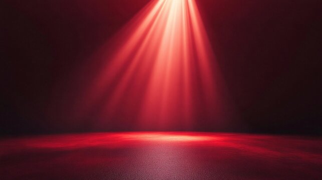 A warm red spotlight illuminates a dark room, casting a focused beam of light that creates a radiant glow on the floor.
