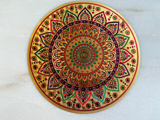 traditional rangoli sticker on golden paper would look vibrant and elegant, blending colorful motifs with the luxurious shine of gold. 