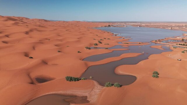 Drone shot over flooded big dunes in morocco desert on sahara merzouga