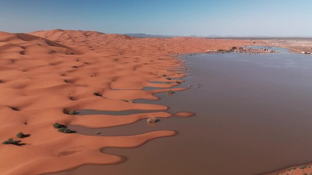 Drone shot over flooded big dunes in morocco desert on sahara merzouga