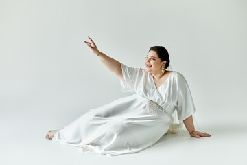 A stunning bride beams while seated in her beautiful gown, exuding joy and elegance on a soft...