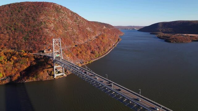Gorgeous drone shot of Hudson River Valley in the fall, Bear Mountain Bridge in the foreground, 4K