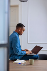 Male worker using his laptop in the office