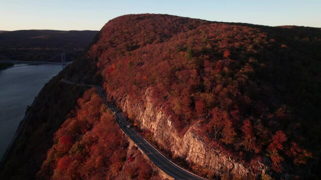Beautiful New York State Highway 9A in the Hudson River Valley, fall colors at golden hour, 4K drone shot