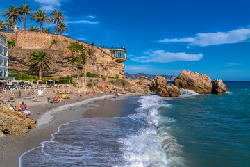 Nerja Chica beach Spain below Balcon de Europa Costa del Sol Andalusia and blue sky and mediterranean sea and waves