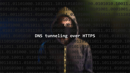 Cyber attack dns tunneling over https text in foreground screen, anonymous hacker hidden with hoodie in the blurred background. Vulnerability text in binary system code on editor program.